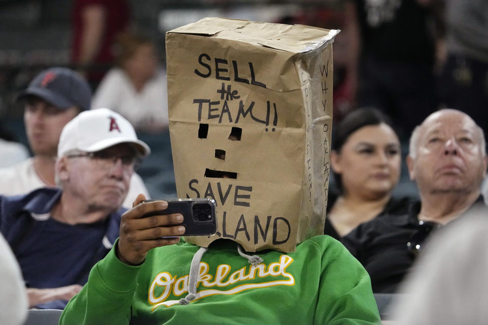 A fan watches from the stands with a bag over his head during the fourth inning of a baseball game between the Los Angeles Angels and the Oakland Athletics Wednesday, April 26, 2023, in Anaheim, Calif. (AP Photo/Mark J. Terrill)