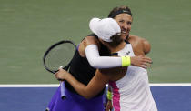 Victoria Azarenka, of Belarus, right, and Ashleigh Barty, of Australia, celebrate after defeating Viktoria Kuzmova, of Slovakia and Aliaksandra Sasnovich, of Belarus, in a semifinal match of the U.S. Open tennis championships Thursday, Sept. 5, 2019, in New York. (AP Photo/Seth Wenig)