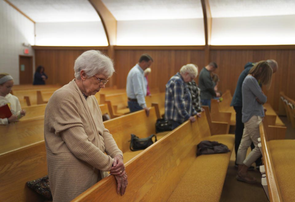 Congregants of the Church of Christ pray after bible study on Wednesday, Sept. 14, 2022, in Zion, Ill. (AP Photo/Jessie Wardarski)
