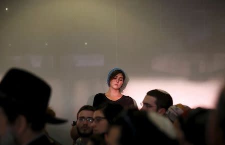 A mourner attends the funeral for Israeli woman Hadar Buchris, 21, in Jerusalem, November 23, 2015. REUTERS/Ronen Zvulun