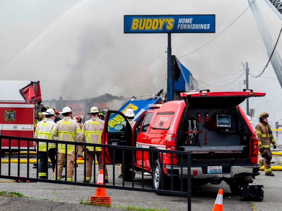 Tacoma firefighters battle a two-alarm fire at Buddy’s Furniture store at 8219 Pacific Avenue in Tacoma, Wash. on Tuesday, May 2, 2023.