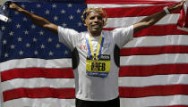 Meb Keflezighi, of San Diego, Calif., celebrates his victory with an American flag after the 118th Boston Marathon Monday, April 21, 2014 in Boston. (AP Photo/Charles Krupa)