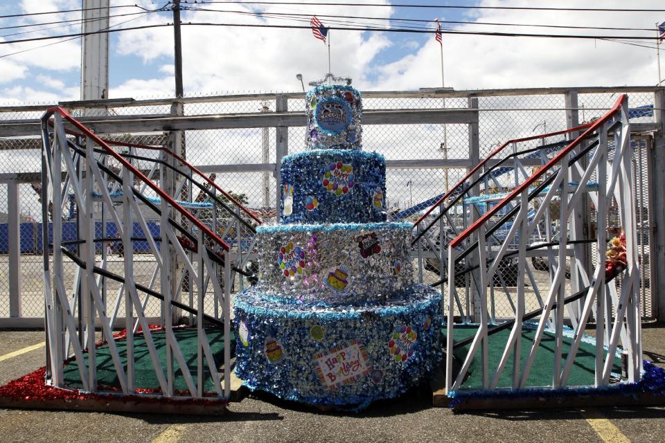 In a Tuesday, June 26, 2012 photo taken on Coney Island in New York, a float marking the Cyclone roller coaster's 85th anniversary and used in the Mermaid Parade is seen in the ride's lot. The New York City landmark and international amusement icon will be feted Saturday, June 30 with a birthday party in its honor. (AP Photo/Mary Altaffer)