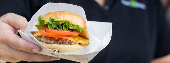 A Shake Shack burger in a paper dish