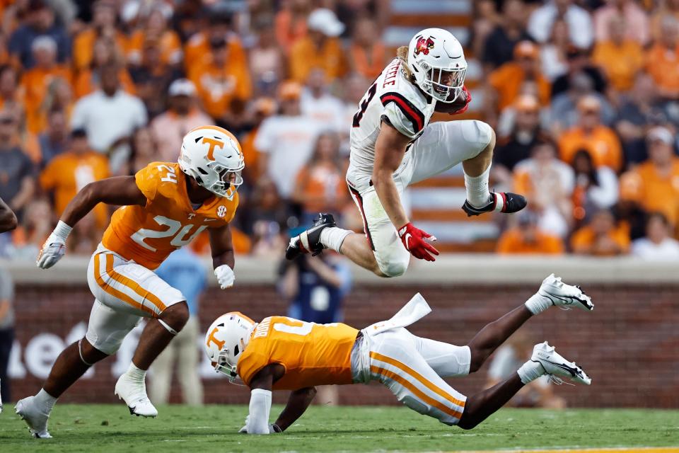 Ball State running back Carson Steele (33) leaps over Tennessee defensive back Warren Burrell (4) as he's chased by linebacker Aaron Beasley (24) during the first half of an NCAA college football game Thursday, Sept. 1, 2022, in Knoxville, Tenn. (AP Photo/Wade Payne)