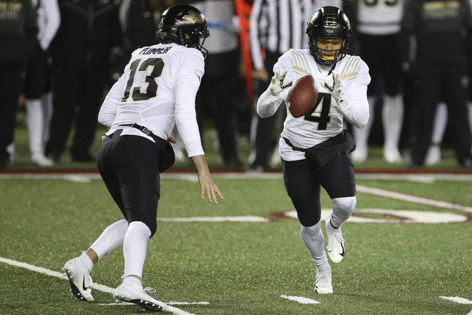 Purdue wide receiver Rondale Moore (4) receives the ball from quarterback Jack Plummer (13) during the first half of the team's NCAA college football game against Minnesota, Friday, Nov. 20, 2020, in Minneapolis. (AP Photo/Stacy Bengs)