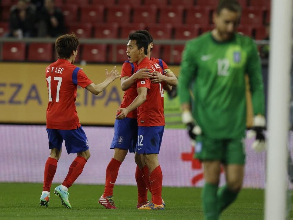 South Korea's Park Chu-young, center, celebrates with his teammates after scoring against Greece during a friendly match at Georgios Karaiskakis stadium in Piraeus port, near Athens, Wednesday, March 5, 2014. (AP Photo/Thanassis Stavrakis)