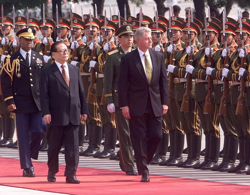 Bill Clinton and Jiang Zemin inspect Chinese troops during a state arrival ceremony in the East Plaza of the Great Hall of the People in Beijing (AFP via Getty Images)