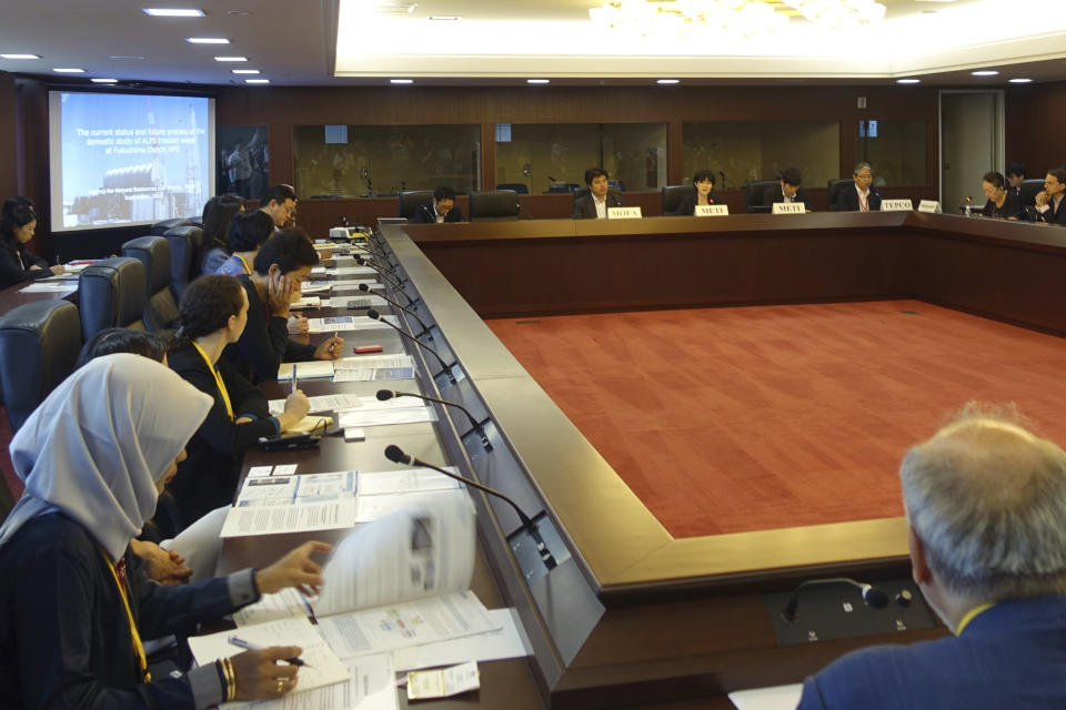 Diplomats from 22 countries attend a briefing on the Fukushima nuclear plant's safety at the foreign ministry in Tokyo, Wednesday, Sept. 4, 2019. Japan has reassured foreign diplomats about the crippled nuclear plant's safety amid concerns about massive amounts of treated but radioactive water stored in tanks. (AP Photo/Mari Yamaguchi)