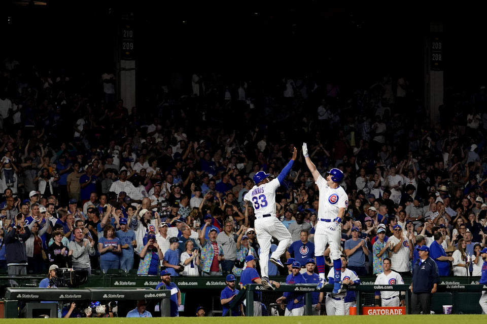 Chicago Cubs' Patrick Wisdom, right, celebrates his two-run home run off Washington Nationals starting pitcher MacKenzie Gore, with third base coach Willie Harris during the seventh inning of a baseball game Monday, July 17, 2023, in Chicago. (AP Photo/Charles Rex Arbogast)