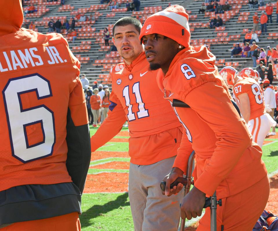 Clemson wide receiver Justyn Ross, on crutches, stands with defensive lineman Bryan Bresee before the home finale against Wake Forest.