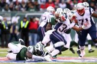 Dec 21, 2014; East Rutherford, NJ, USA; New England Patriots running back Shane Vereen (34) runs out of a tackle by New York Jets defensive end Muhammad Wilkerson (96) during the third quarter at MetLife Stadium. The Patriots defeated the Jets 17-16. Mandatory Credit: Brad Penner-USA TODAY Sports