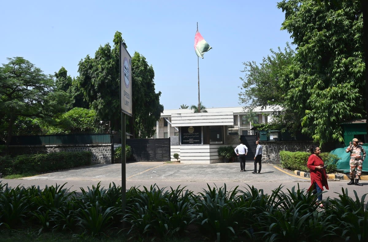 People stand outside the Afghan Embassy in New Delhi (Associated Press)