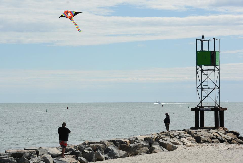 Billy Haddad, of Holden, flies a kite over the jetty at Bass River Beach.