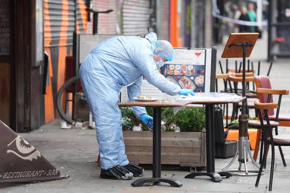 A police forensic officer at the scene of a shooting at Kingsland High Street on Friday (James Manning/PA Wire)