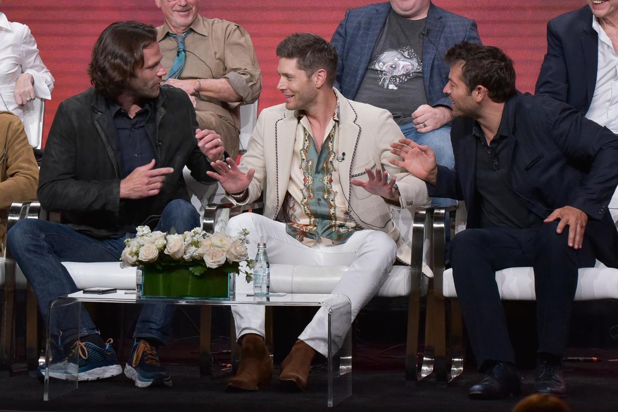 Actors Jared Padalecki, left, Jensen Ackles and Misha Collins share a moment during a CW panel on the final season of their hit drama, 