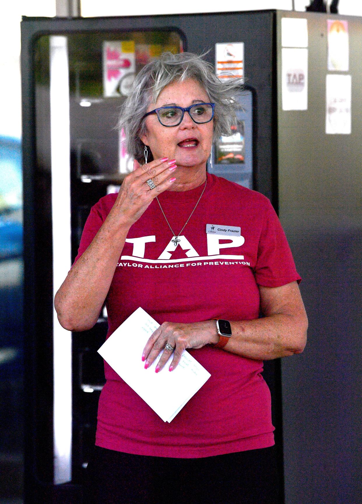 Cindy Frazier addresses the crowd during the dedication of the Narcan vending machine in front of Book Therapy in Abilene July 31. The medicine is available 24 hours at no cost.