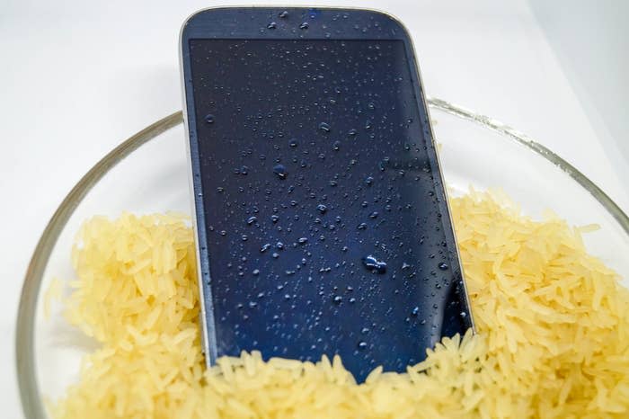 wet smartphone in a bowl of rice