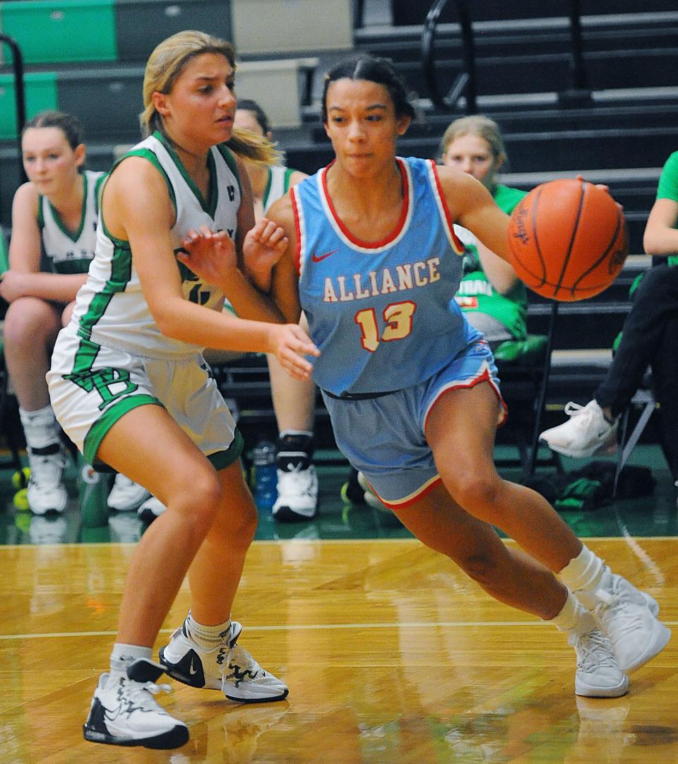 Alliance's Ella Smith drives around West Branch's Chloe Dennison in an Eastern Buckeye Conference game Wednesday, December 7, 2022 at the West Branch Field House.