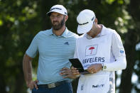 Dustin Johnson waits on the 11th tee with his caddie during the first round of the Travelers Championship golf tournament at TPC River Highlands, Thursday, June 24, 2021, in Cromwell, Conn. (AP Photo/John Minchillo)