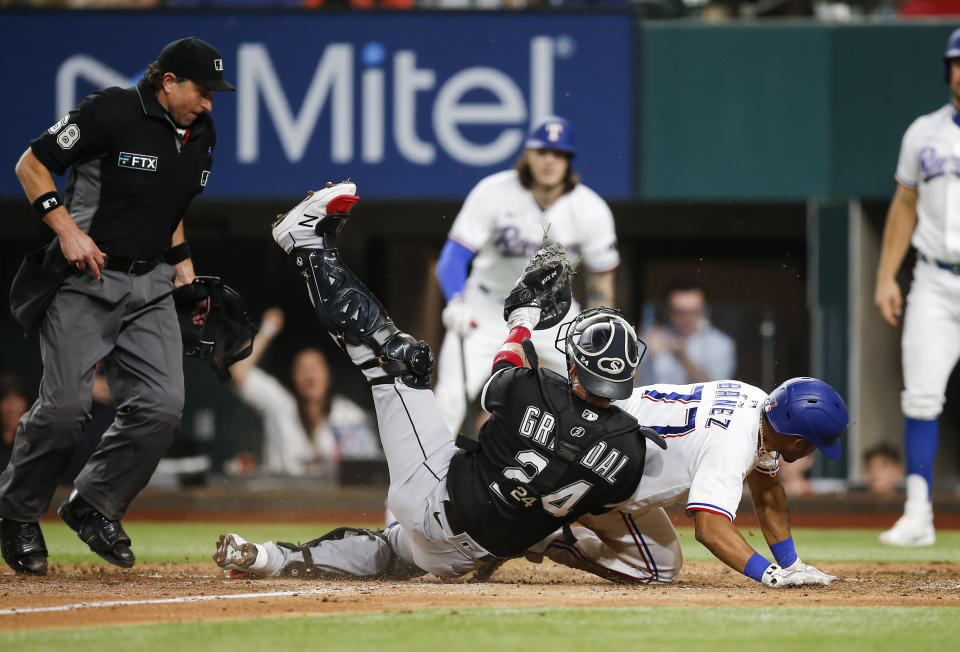 Chicago White Sox catcher Yasmani Grandal (24) tags out Texas Rangers' Andy Ibanez (77) during the sixth inning of a baseball game, Saturday, Sept. 18, 2021, in Arlington, Texas. (AP Photo/Brandon Wade)