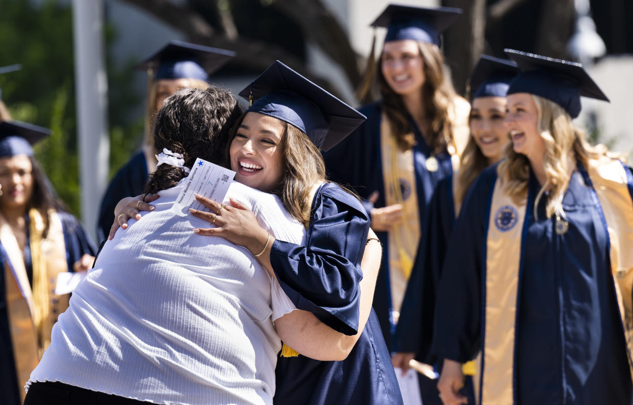 Yesica Manilla is hugged before graduation ceremonies held at Mariners Church in Irvine, CA on May 5, 2022. (Photo by Paul Bersebach/MediaNews Group/Orange County Register via Getty)