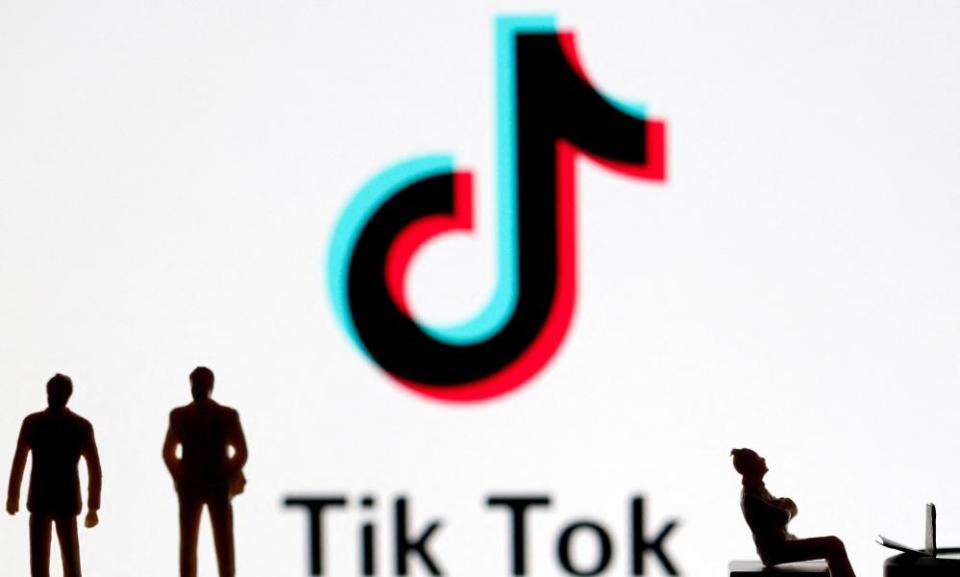 3D printed figures in front of displayed TikTok logo