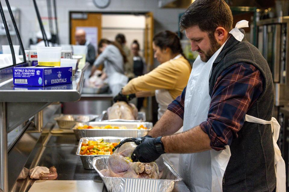 Cory Carter stuffs a turkey Monday for the annual Turkey Tango to feed Homeless Alliance at Francis Tuttle Culinary Arts in Oklahoma City.