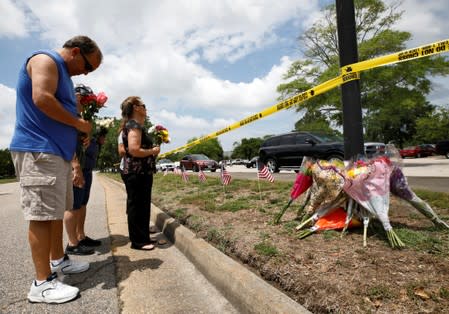 Vic Wirhowski, a local municipal worker, bows his head as he pays his respects at a makeshift memorial outside a municipal government building where a shooting incident occurred in Virginia Beach, Virginia