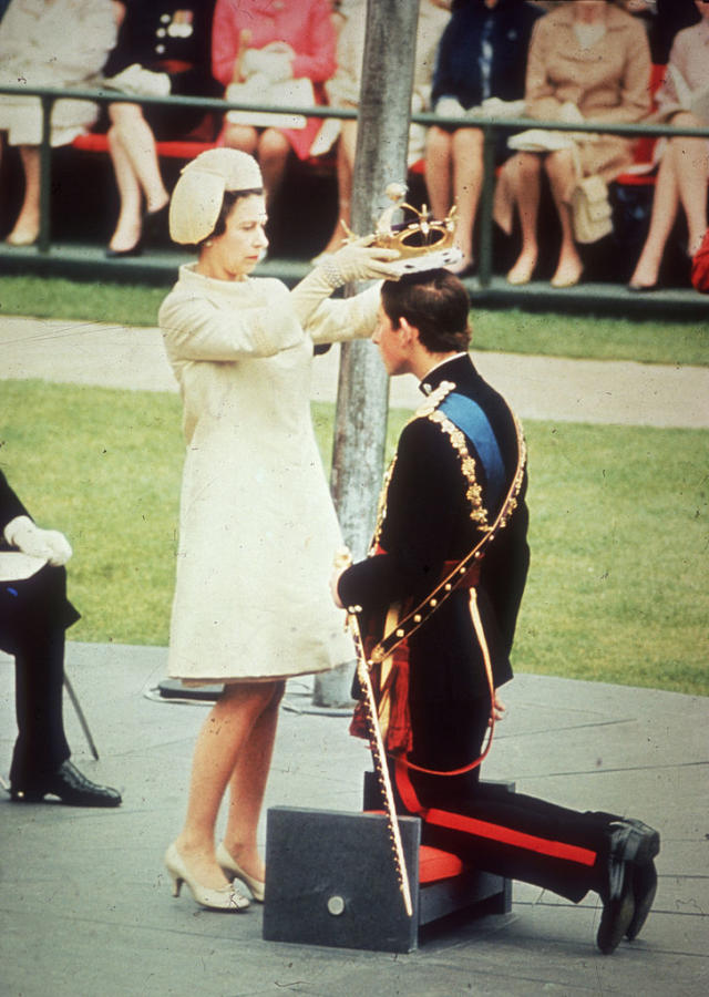 Elizabeth crowns her son Charles, Prince of Wales, during his investiture ceremony at Caernarvon Castle in July 1969. (Photo by Hulton Archive/Getty Images)