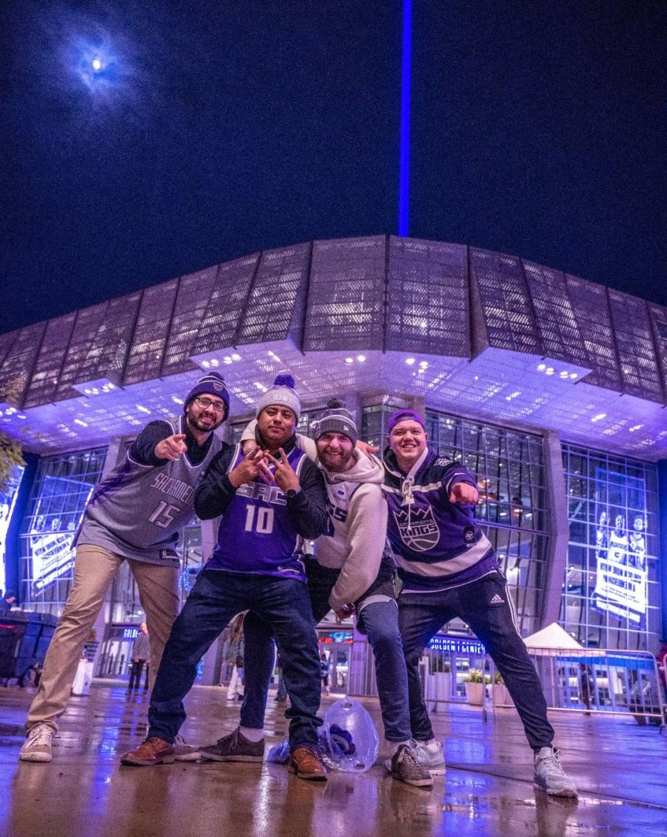 Sacramento Kings fans Farham Kakar, Rigoberto Vasquez, Nijal Martin and Isaias Edel celebrate the Kings’ 110-101 victory against the Chicago Bulls in front of the victory beam on Sunday, Dec. 4, 2022, at Golden 1 Center in Sacramento.