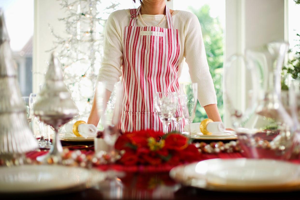 Woman Standing by Table Decorated for Christmas