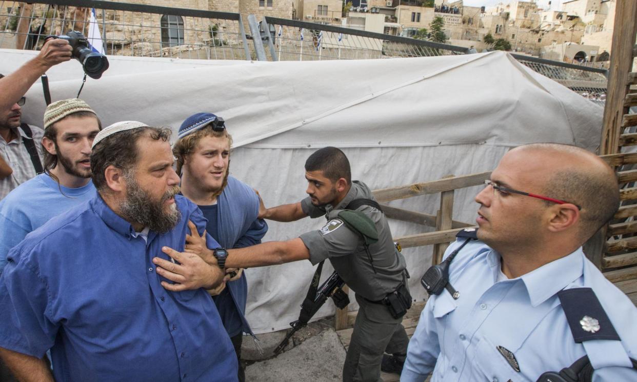 <span>Bentzi Gopstein (second from left), the leader of the far-right group Lehava, in 2014.</span><span>Photograph: Jack Guez/AFP/Getty Images</span>