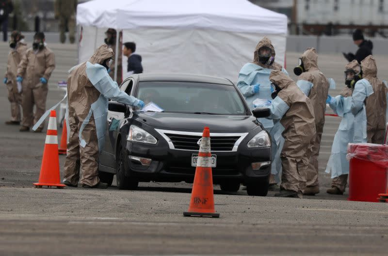 Members of the Colorado Air National Guard test people who suspect they are infected with coronavirus disease (COVID-19), at a drive-thru testing station, in Denver