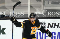 Boston Bruins center Craig Smith raises his stick after scoring the game-winning goal against the Pittsburgh Penguins during an overtime period of an NHL hockey game, Tuesday, Jan. 26, 2021, in Boston. The Bruins won 3-2. (AP Photo/Charles Krupa)