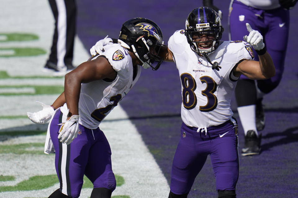 Baltimore Ravens wide receiver Willie Snead (83) celebrates a touchdown by Baltimore Ravens running back J.K. Dobbins (27), during the second half of an NFL football game, Sunday, Sept. 13, 2020, in Baltimore, MD. (AP Photo/Julio Cortez)