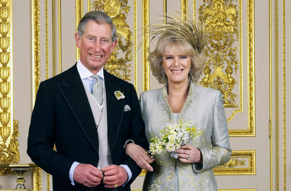 Prince Charles, the Prince of Wales and his new bride Camilla, Duchess of Cornwall pose for their official photograph in the White Drawing Room at Windsor Castle following their marriage. Dress by Robinson Valentine, hat by Philip Treacy. | Location: Windsor, United Kingdom UK. (Photo by © Pool Photograph/Corbis/Corbis via Getty Images)