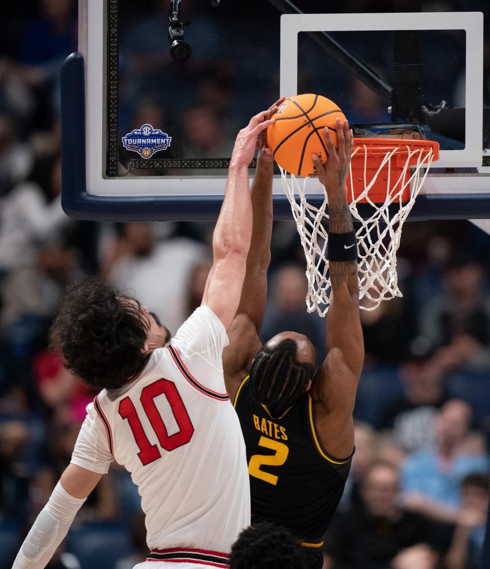 Missouri Tigers guard Tamar Bates (2) is blocked from behind by Georgia Bulldogs guard RJ Sunahara (10) during their first round SEC Men's Basketball Tournament at Bridgestone Arena in Nashville, Tenn., Wednesday, March 13, 2024.