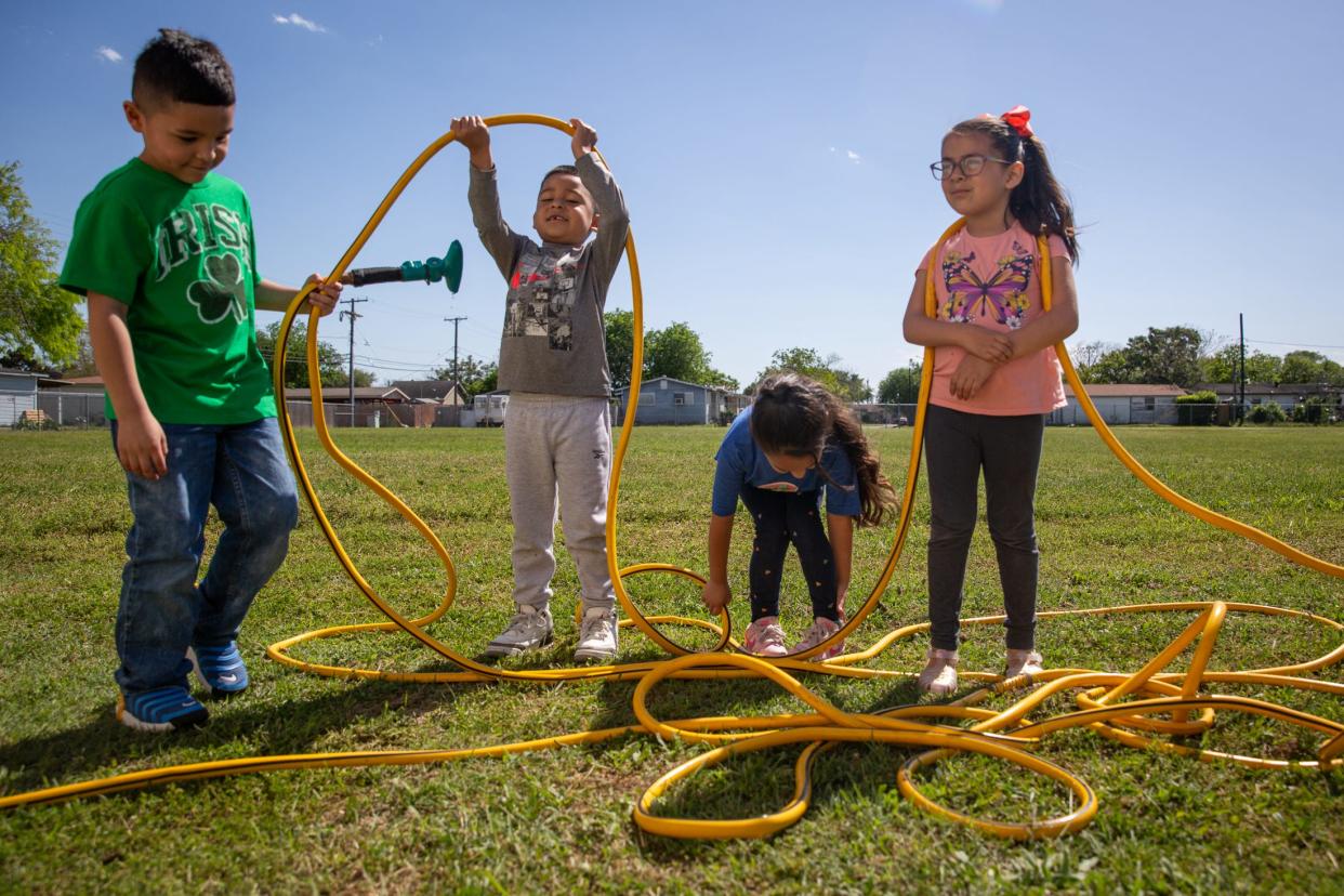 Kindergarten students, from left, Jace Zuniga, Aiden Perez, Olivia Villarreal and Elizabeth Ramirez collect a hose after watering a garden during an aftercare program at Garcia Elementary School on Thursday, March 28, 2024, in Corpus Christi, Texas.