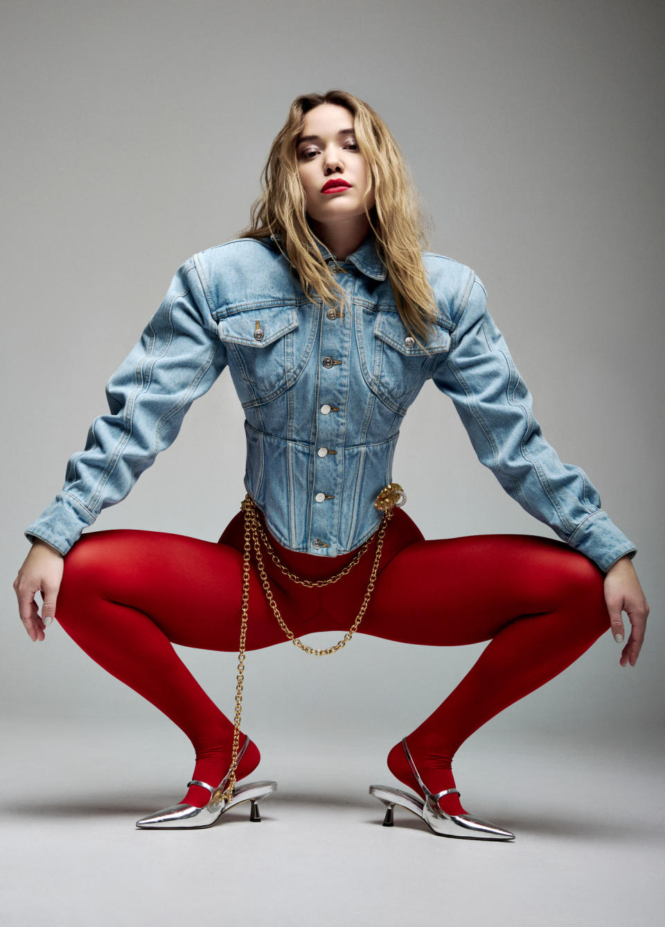 Olivia Ponton photographed at PMC Studios on March 13, 2024. Olivia Ponton wears Mugler denim jacket, Jimmy Choo mules, Calzedonia red tights and Schiaparelli belt.