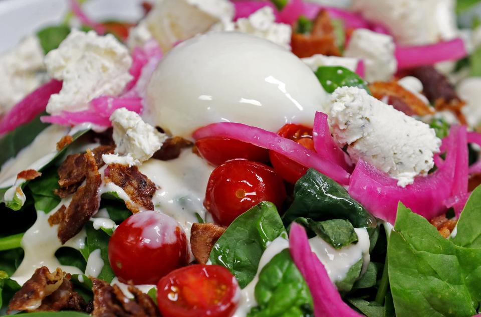 Barrelhouse's spinach salad with bacon, grape tomatoes, pickled red onion, white French dressing and a poached egg.