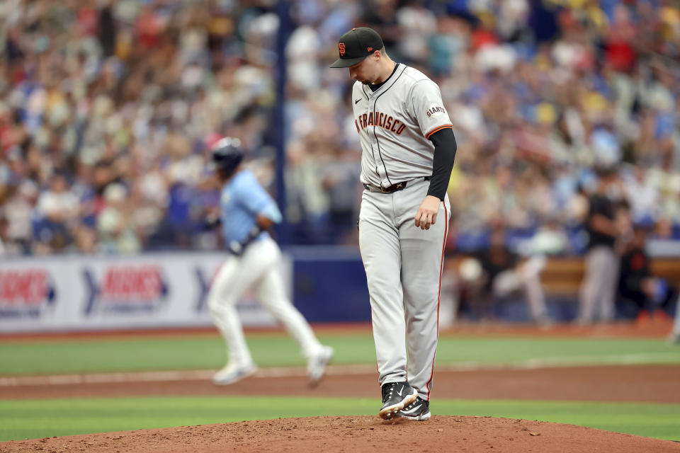 San Francisco Giants starting pitcher Blake Snell reacts on the mound after giving up a three-run home run to Tampa Bay Rays' Rene Pinto, rounding the bases, during the fourth inning of a baseball game Sunday, April 14, 2024, in St. Petersburg, Fla. (AP Photo/Mike Carlson)