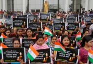 Students hold placards during a vigil to pay tribute to Central Reserve Police Force (CRPF) personnel who were killed after a suicide bomber rammed a car into a bus in south Kashmir on Thursday, in Agartala, India February 16, 2019. The placards read "Tribute to brave sons of mother India martyred in Kashmir". REUTERS/Jayanta Dey