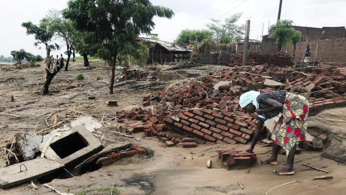 A woman looks for her belongings, after the Tropical Storm Ana hit the district of Tete, Mozambique, 27 January 2022.