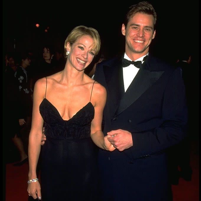 American actor Jim Carrey and his partner, actress Lauren Holly, at the 1996 Fire and Ice Ball at the Warner Brothers Studios in Hollywood, California, 1996.