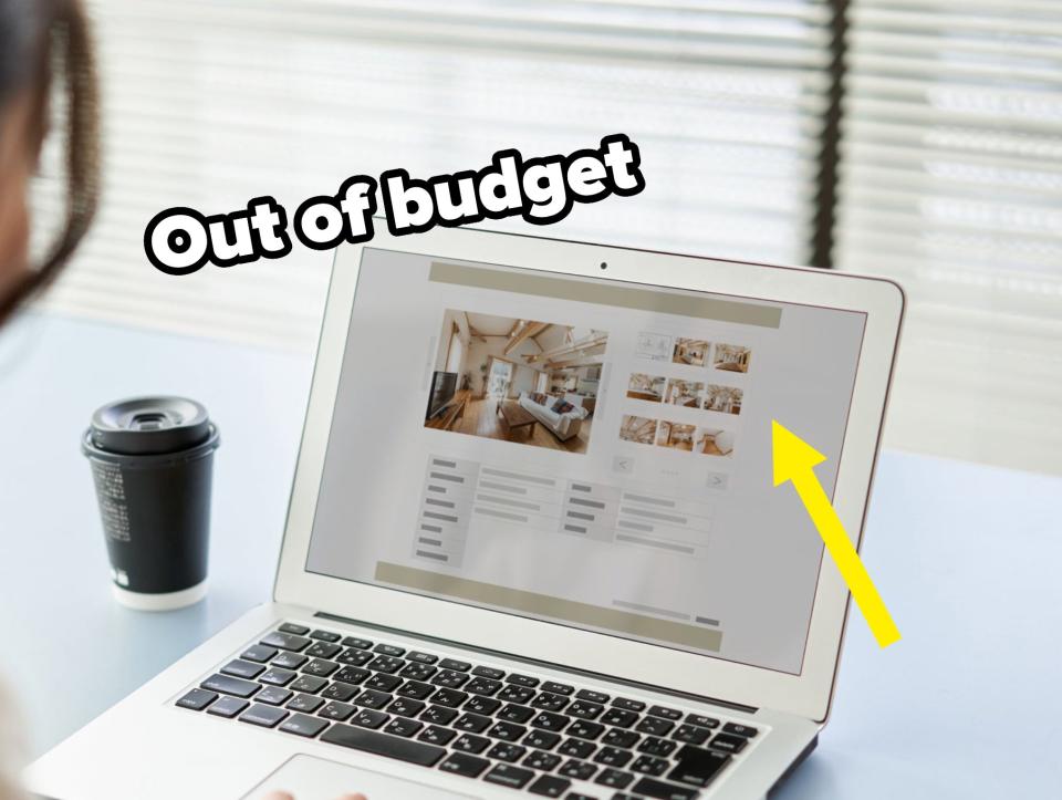 A person is sitting at a desk, viewing a website on a laptop, with a coffee cup nearby. The website displays interior images and text, suggesting property listings or design ideas