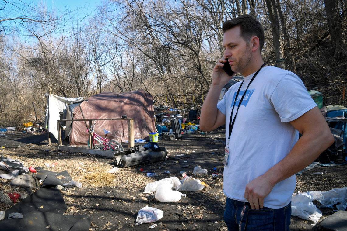 Josh Henges, homelessness prevention coordinator, for Kansas City, takes a phone call about an encampment with 20 people living in it as he walks through another encampment on Wednesday, March 2, 2022, in an area near Independence Avenue. Henges was conducting a count of sheltered and unsheltered people experiencing houselessness.