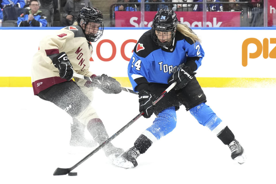 Toronto's Natalie Spooner shoots as Montreal's Kati Tabin defends during the third period of a PWHL hockey game Friday, Feb. 16, 2024, in Toronto. (Chris Young/The Canadian Press via AP)