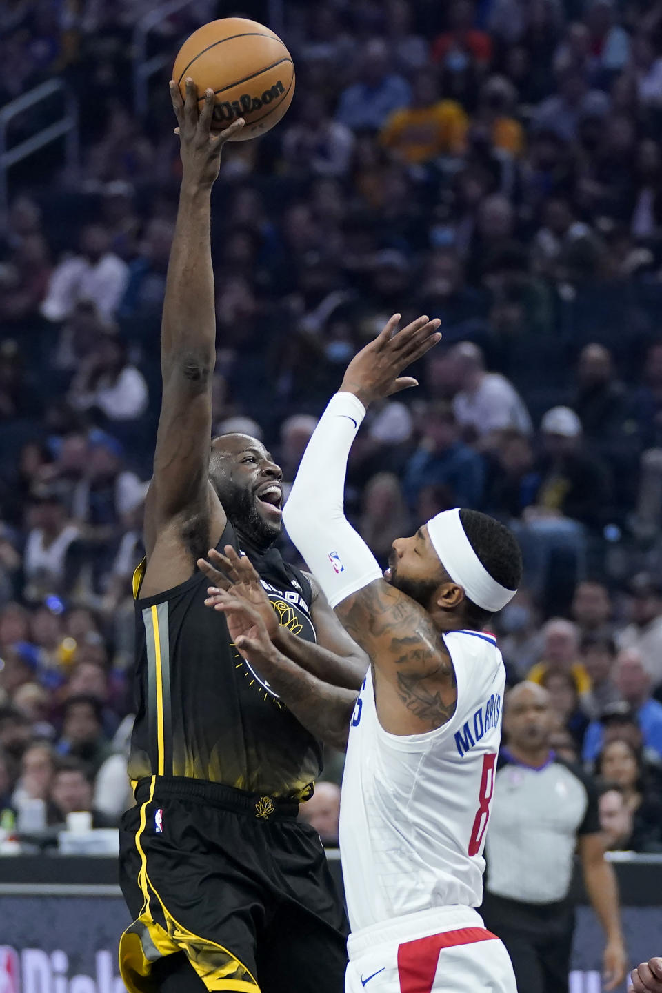 Golden State Warriors forward Draymond Green, left, shoots against Los Angeles Clippers forward Marcus Morris Sr. during the first half of an NBA basketball game in San Francisco, Wednesday, Nov. 23, 2022. (AP Photo/Jeff Chiu)