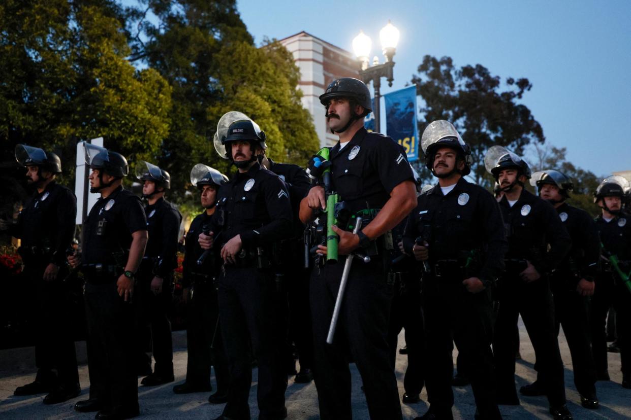 <span>Police officers in riot gear on campus at UCLA last week.</span><span>Photograph: Étienne Laurent/AFP/Getty Images</span>